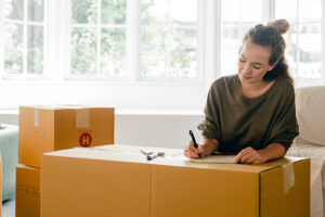 A woman labeling boxes