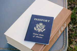 A passport with suitcase.