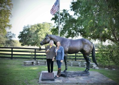 Carol Harris posting next to a horse statue at Bo-Bett Farm