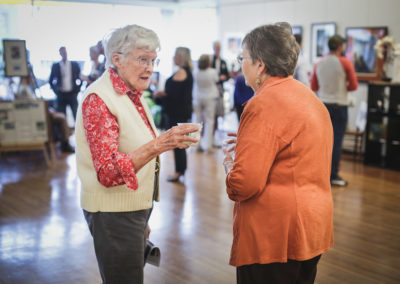 Two women chatting at the Hometown Derby Connections Opening Reception