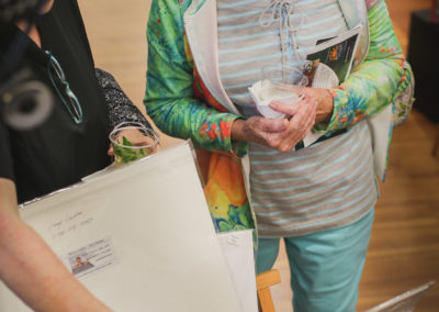 Women looking at artwork at the Hometown Derby Connections Exhibit