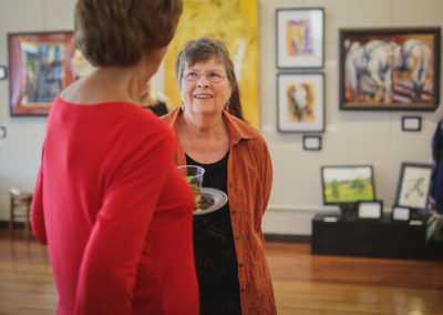 Women talking at the Hometown Derby Connections Exhibit