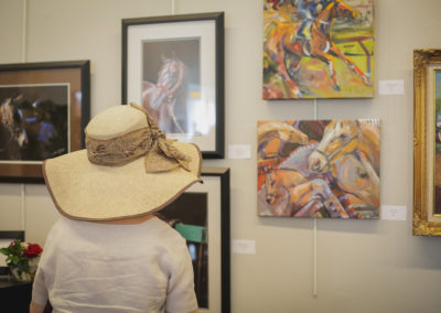Woman looking at artwork at the Hometown Derby Connections Exhibit