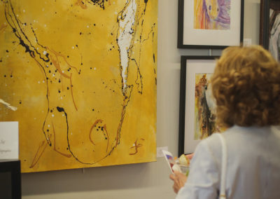 Woman looking at artwork at the Hometown Derby Connections Exhibit