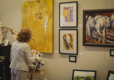 Woman looking at artwork at the Hometown Derby Connections Exhibit