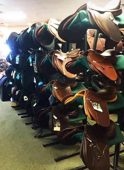 An assortment of leather saddles.