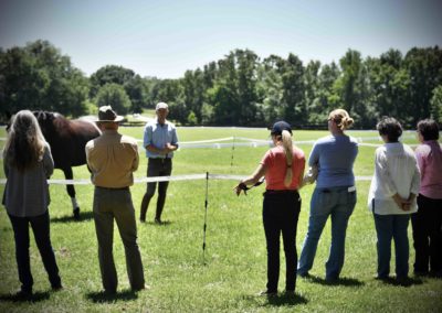 A man speaking to a group of spectators