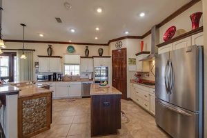 A large kitchen with stainless steel appliances.