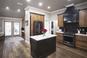 An elegant kitchen in black and white with natural wood.