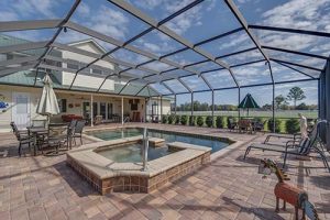 A pristine swimming pool with hot tub.
