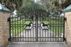 An ornate iron gate with horses.
