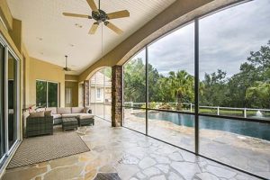 A large enclosed patio with a view of the pool.