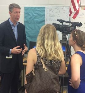 Kevin Sheilley speaking with two women.