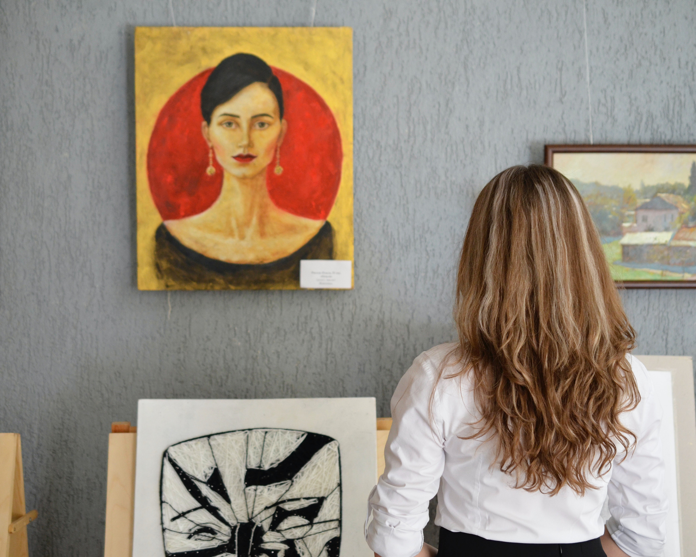 A woman viewing art in a gallery