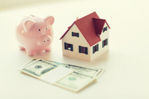 A piggy bank, money, and house.