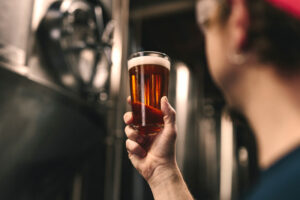 A man holding a glass of beer