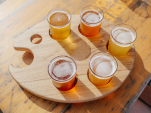 Glasses of beer in a palette shaped holder.