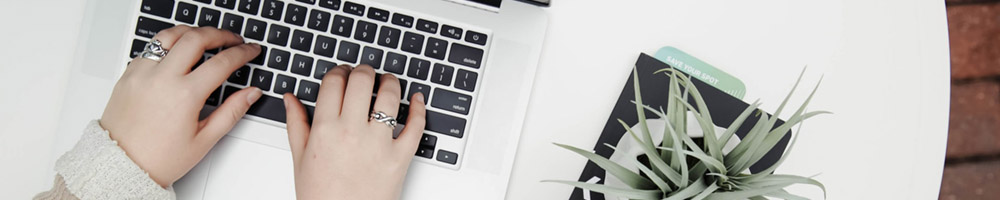 A woman typing on a keyboard.