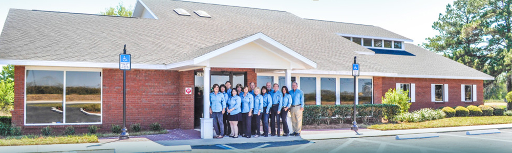 The Showcase Team in front of their new building.