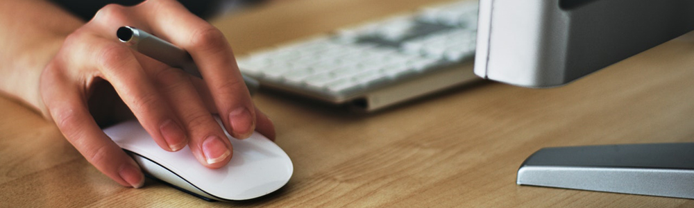 A person at a computer using a mouse