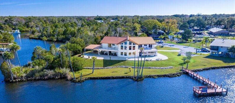 A home resting on the shores of a lake.