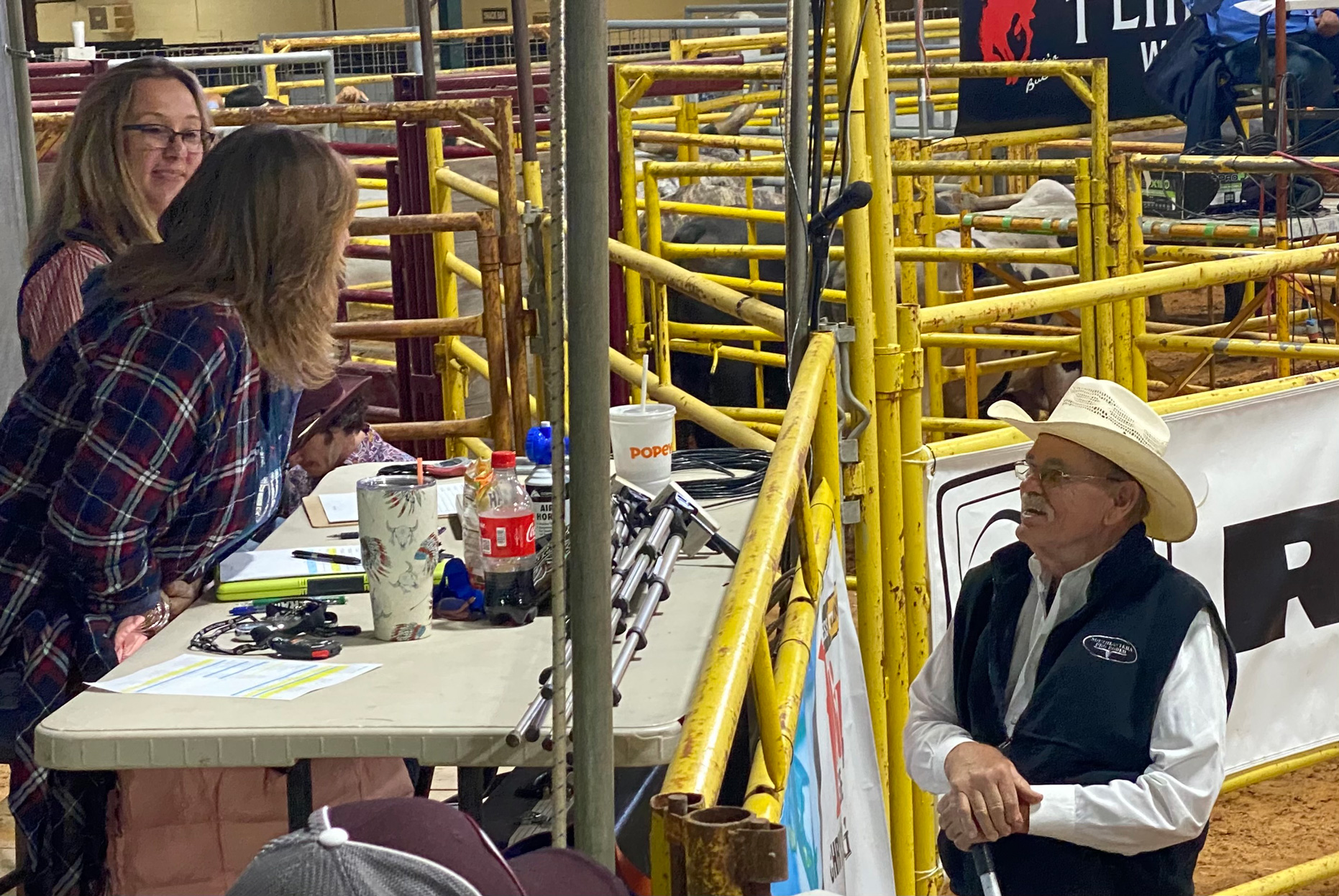 Ruben Lamb speaks to two audience members at the Southeastern Pro Rodeo in 2021.