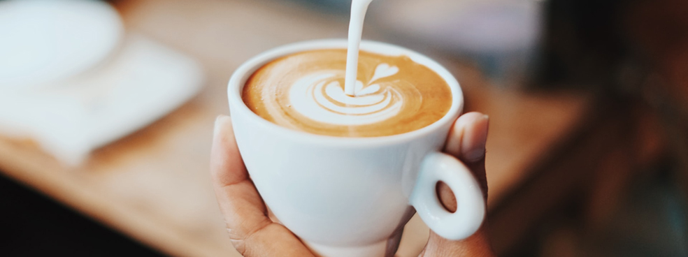 A foamy latte with decorative frothed milk.