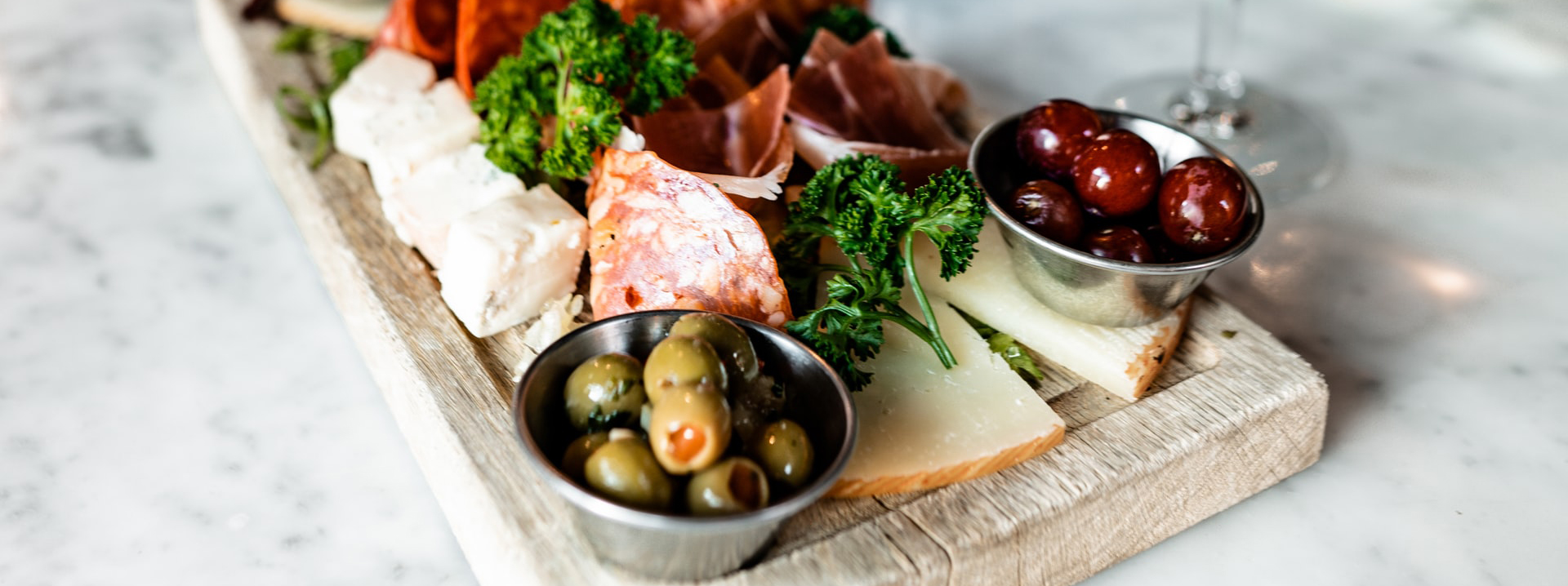 A cutting board covered with charcuterie selections.