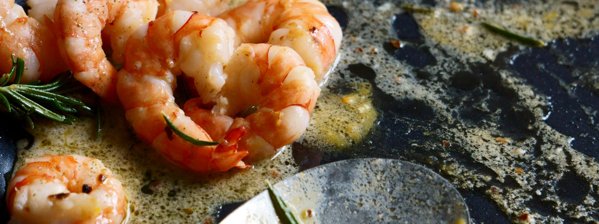 Pink shrimp sauteed in melted butter.