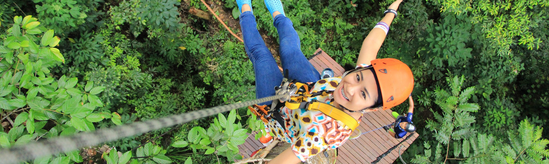 A girl using pulleys to climb a tree.