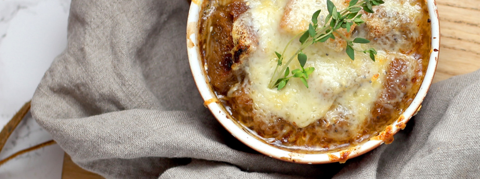 French onion soup with melted cheese on top.