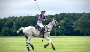 A polo player getting ready hit the ball.