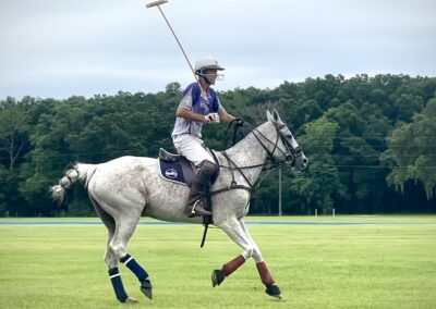 A polo player getting ready hit the ball.