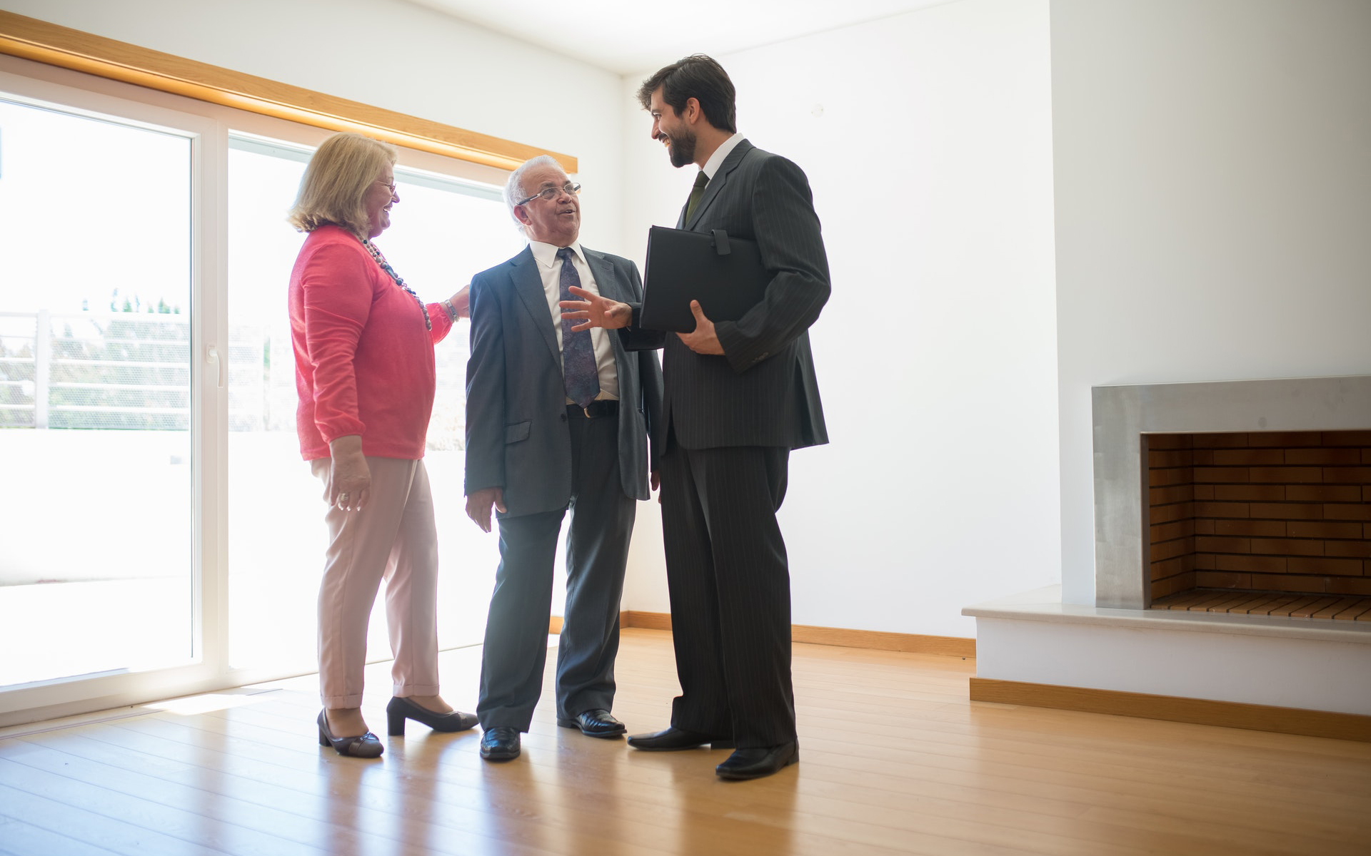 A senior couple being shown a home by a REALTOR®