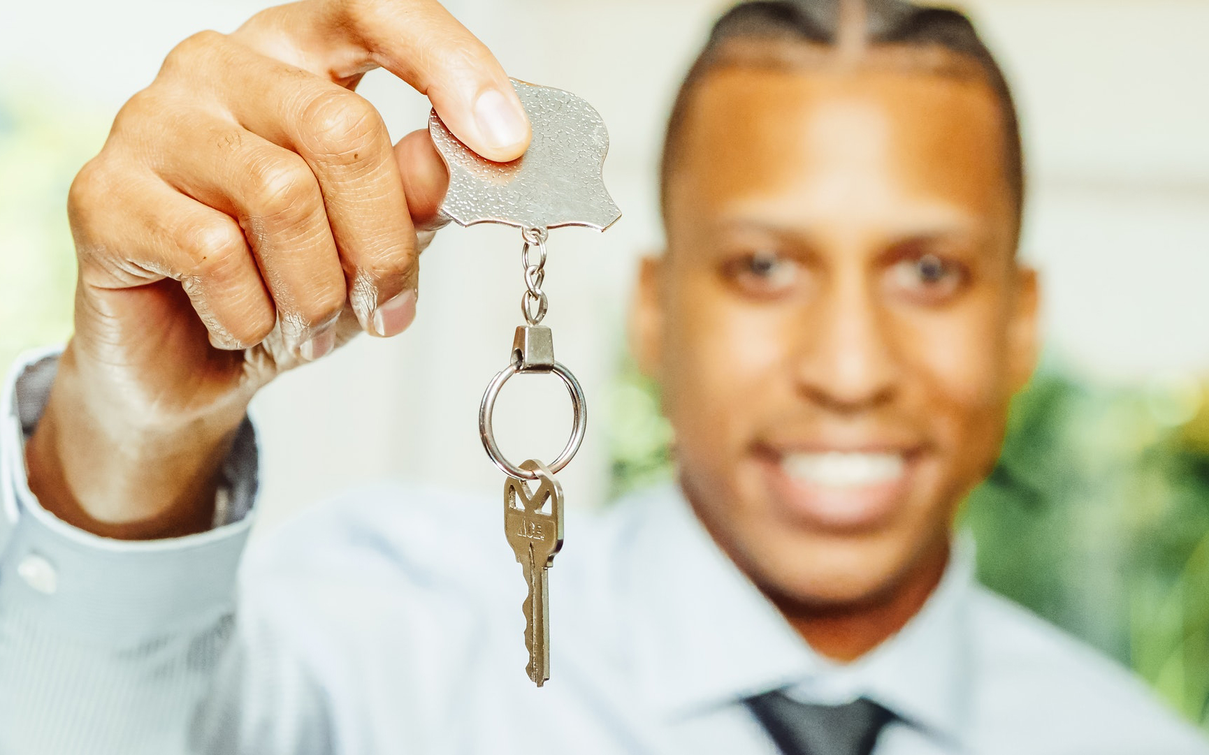 A real estate agent holding the keys to a home.