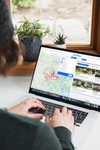 A person using Zillow on their laptop.