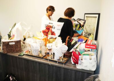 Noris N Roche and Linda Adamson working on gift baskets for the event.