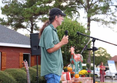 Paul Ware speaking as Hope looks on in the distance.