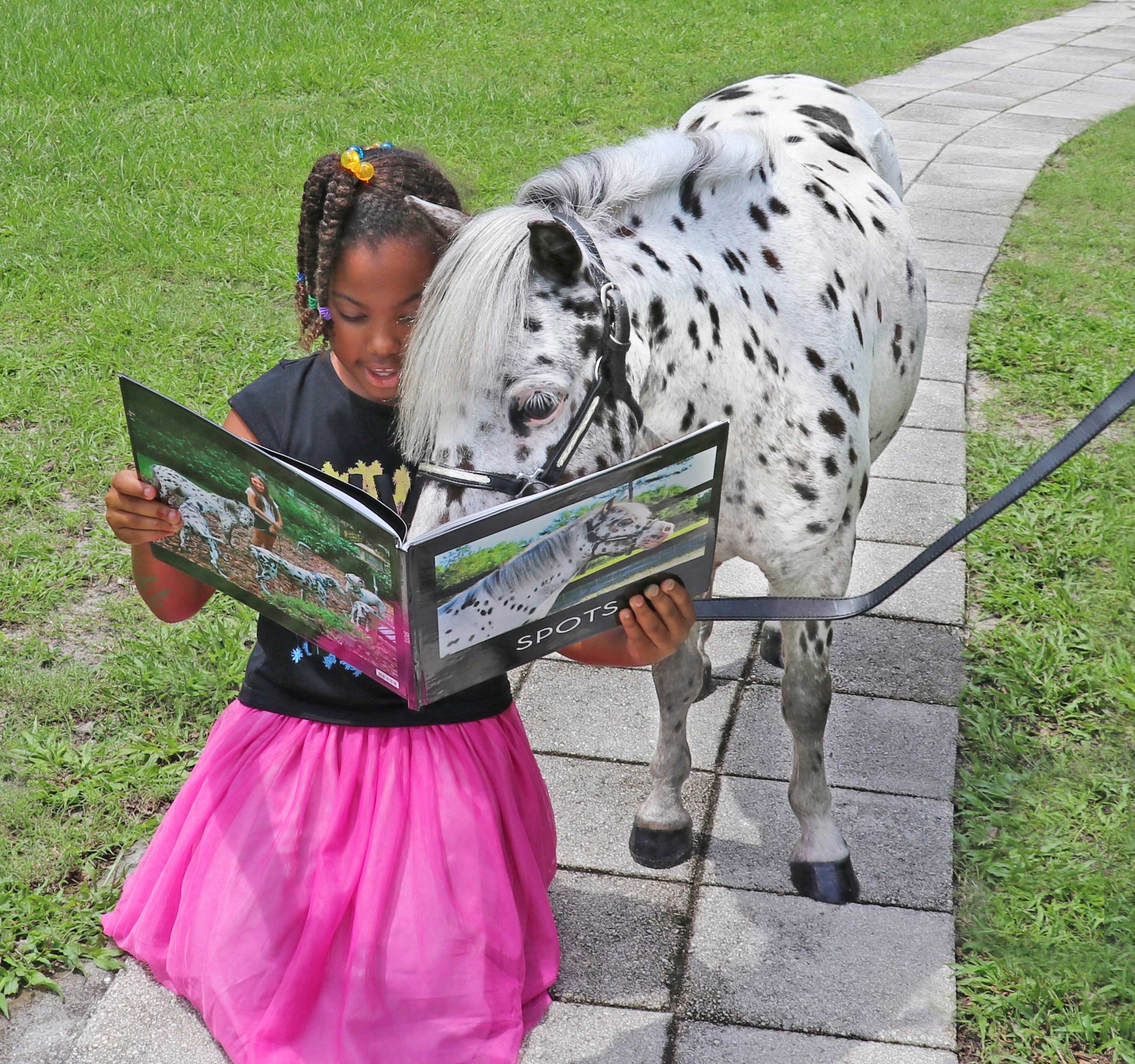 Circus and his new friend looking at a book called "Spots".