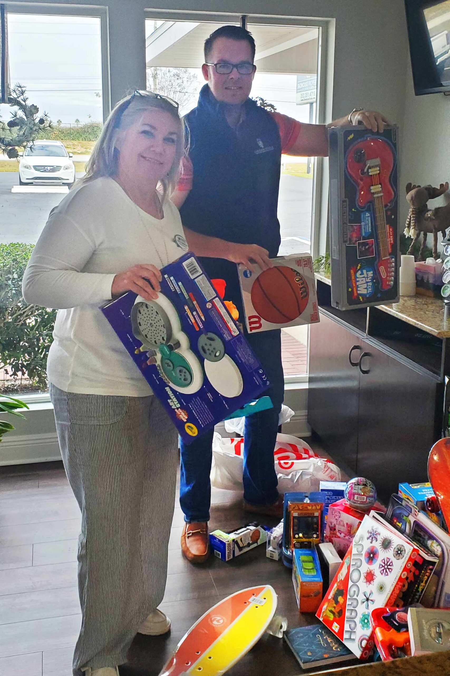 Kelly and Clayton sort gifts for the toy drive.