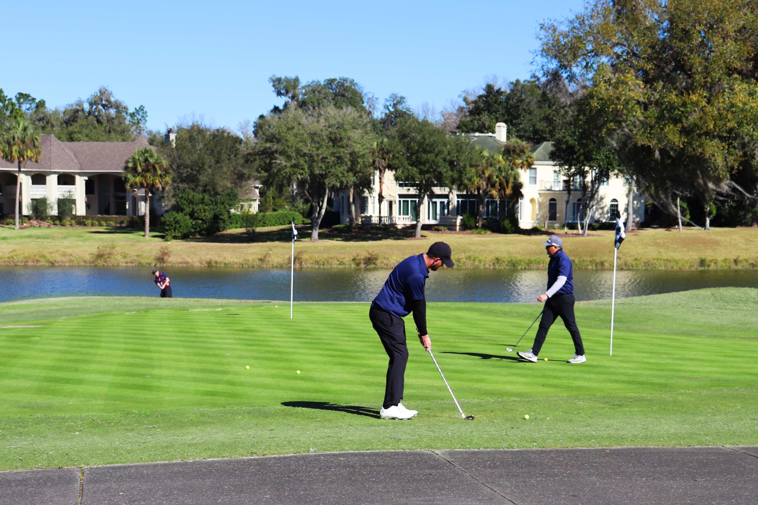 A tournament golf prepares to hit the ball.