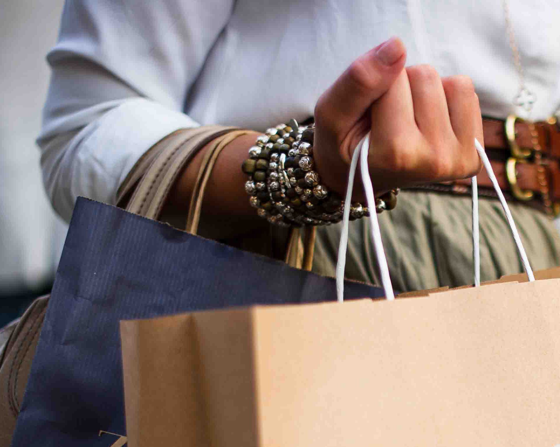 A woman carrying several shopping bags.