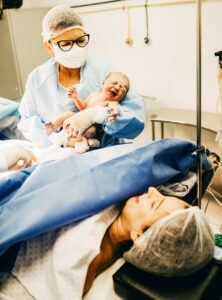 A woman meets her newborn for the first time.