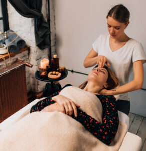 A woman receives a head massage.