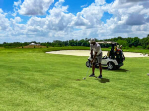 A tournament. golfer prepares to hit the ball. 