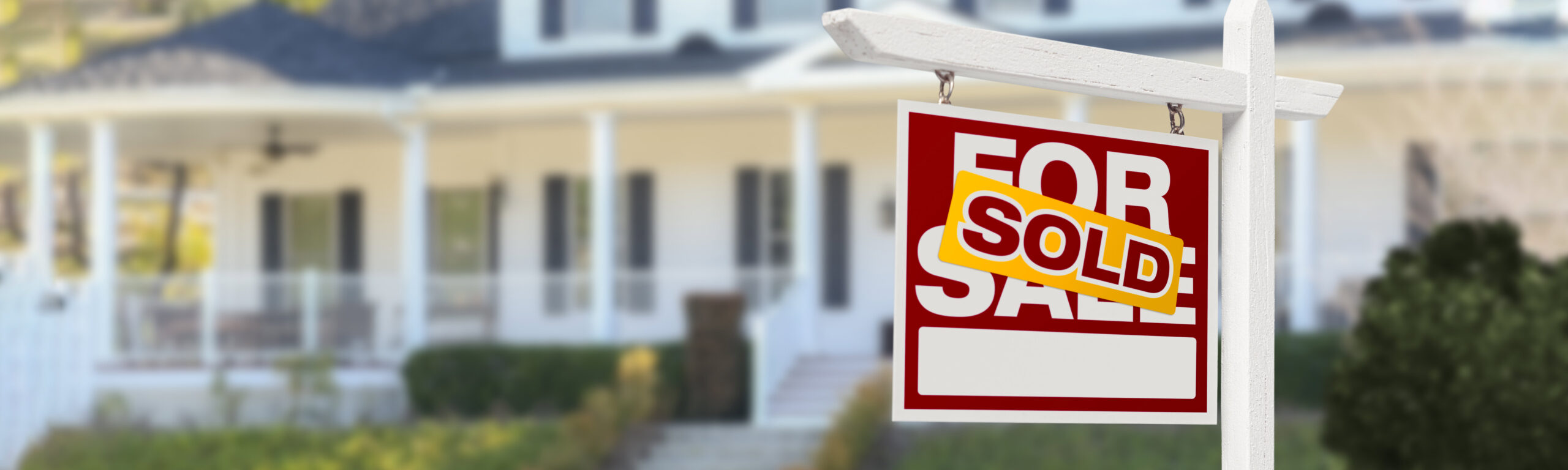 A house with a sold sign