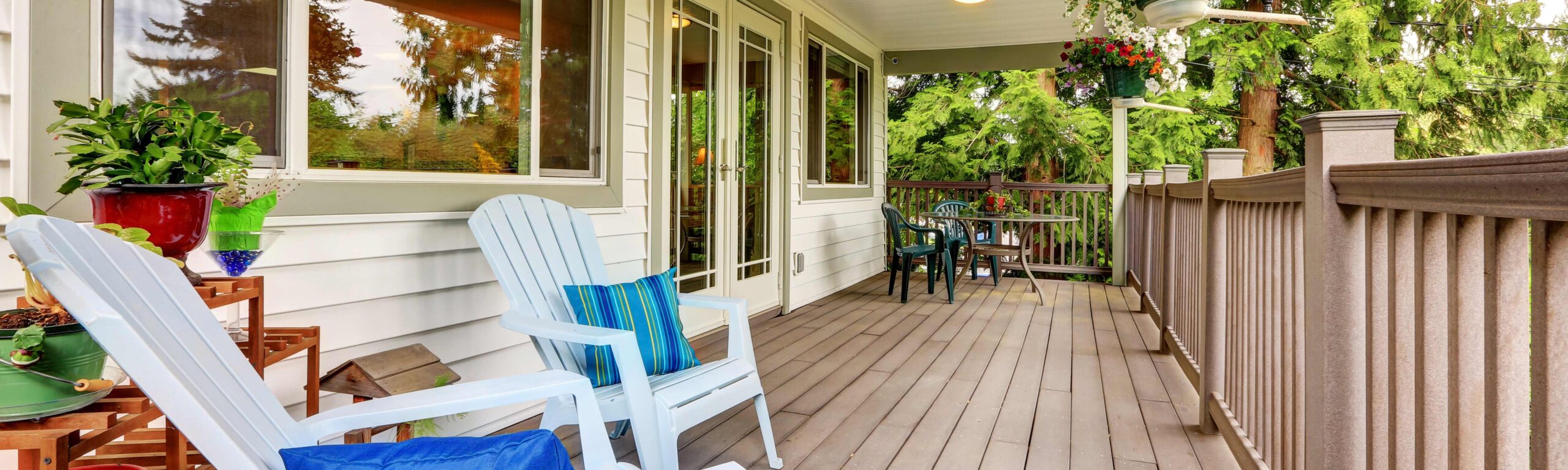 An inviting front porch with seating and potted plants.