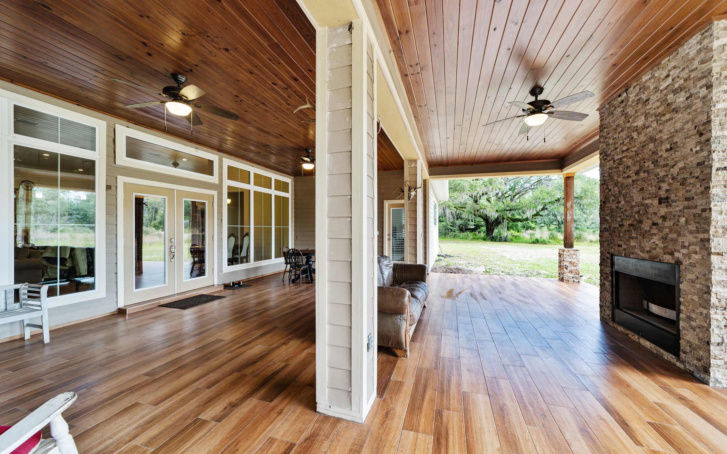 The large covered porch with floor-to-ceiling-fireplace.