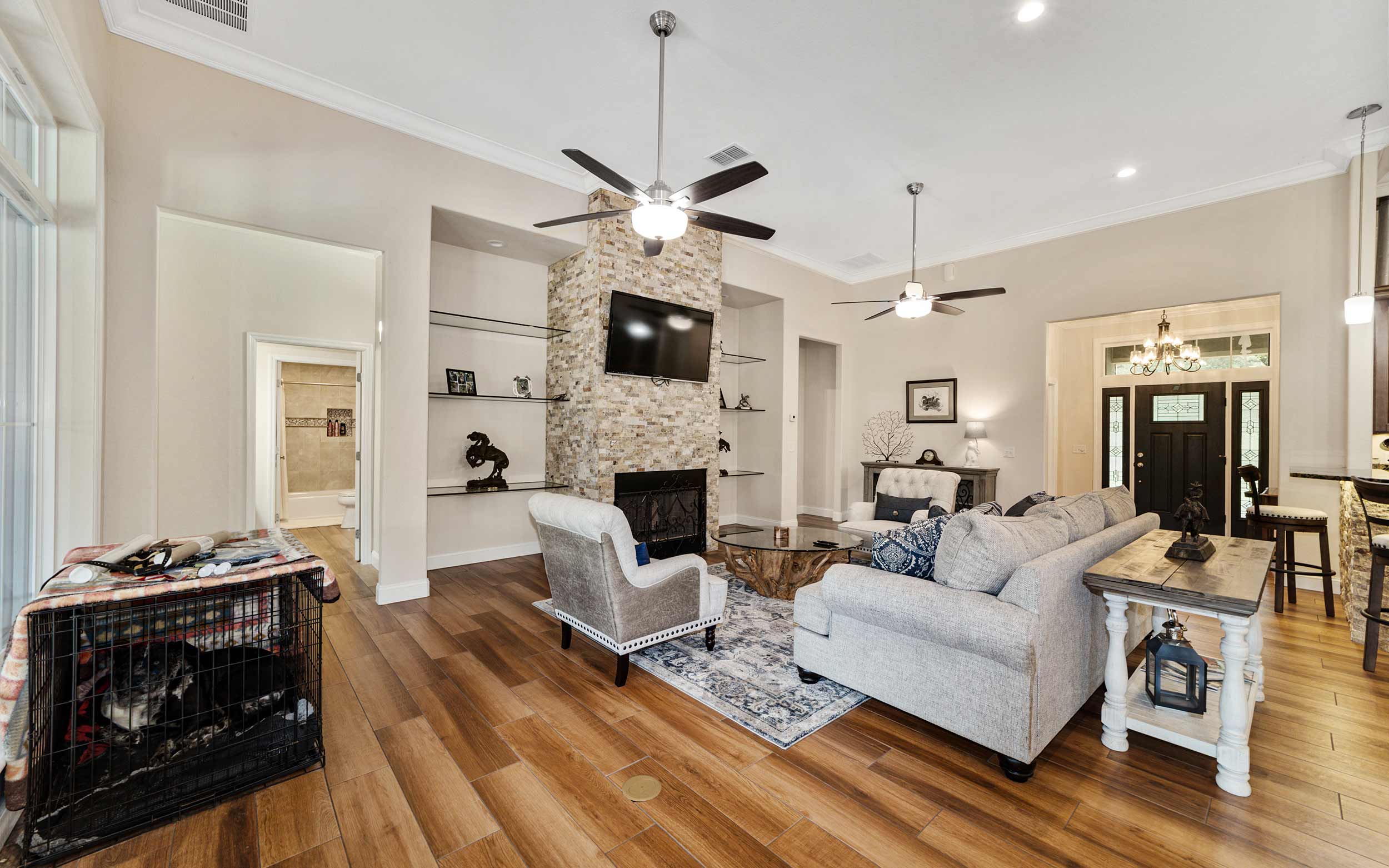 The main living area with built-in bookshelves and floor-to-ceiling stone fireplace.