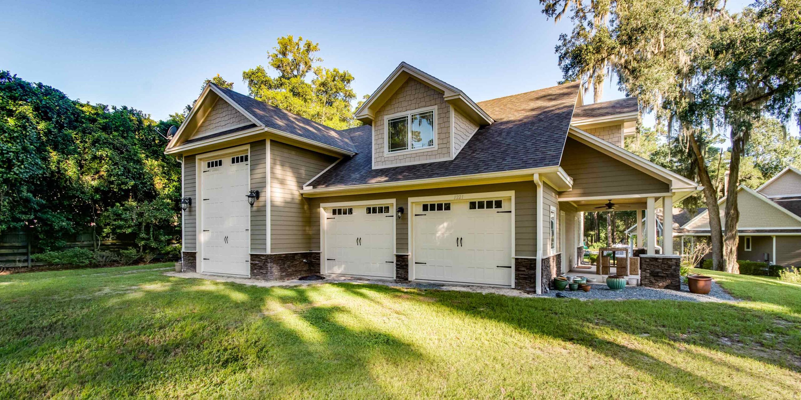 The cedar-sided garage.